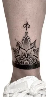 Mandala tattoo on leg showcasing geometric design in black ink.