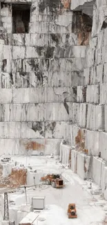 A stunning marble quarry with large stone walls and machinery.