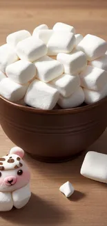 Bowl of marshmallows with cute bear toy on wooden table.