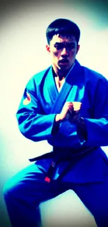 Martial artist in blue uniform striking a fierce pose.