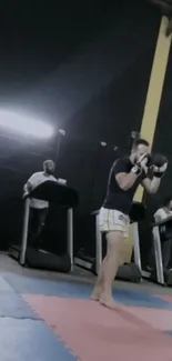 Martial arts training in a gym setting with treadmills and punching stance.