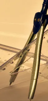 Metallic compasses with rulers on beige background.