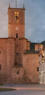 A medieval church building at dusk with historical architecture and stone façade.