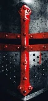 Close-up of medieval knight helmet with red cross.