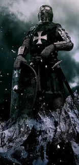 Medieval knight on rocky mountain under dark clouds wallpaper.