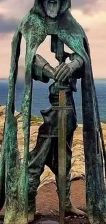 Medieval knight statue by the ocean, standing with a sword.