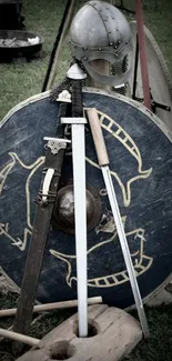 Medieval armor with shield and swords on grass.