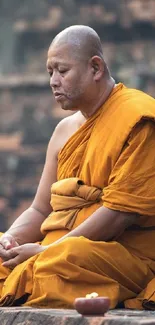 Monk meditating in golden robes, exuding peace and serenity on a tranquil background.