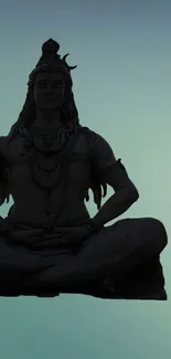 Silhouette of Shiva in meditation on blue-green background.