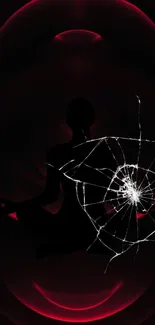 Silhouette meditating within an abstract red and black web design.