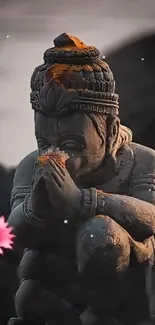 Stone statue surrounded by floating pink petals in a serene setting.