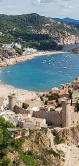 Mediterranean coastal town with beach and stone structures, perfect for mobile wallpaper.