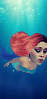 Mermaid with vibrant red hair swimming underwater in a blue ocean scene.