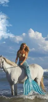 Mermaid riding a unicorn in the ocean under a blue sky.