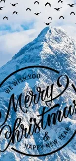 Merry Christmas message on snowy mountain with birds in the sky.