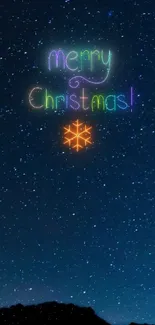 Merry Christmas text over a starry night sky wallpaper.