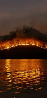 Nighttime fire reflection over water wallpaper.