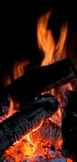 Warm and cozy fireplace with glowing logs and vibrant flames.