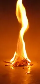 A single orange flame on a dark background.