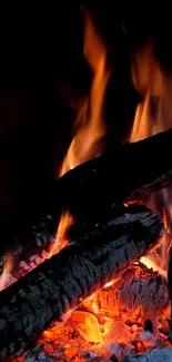 Wallpaper of burning logs with vibrant fire flames.