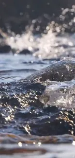 Dynamic ocean waves crashing on rocky shore in a serene mobile wallpaper.