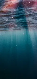 Underwater view with sunlight rays merging in tranquil ocean blue.