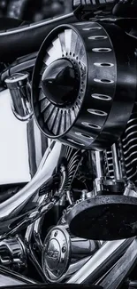 Black and white close-up of a motorcycle engine showcasing metallic details.