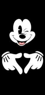 Mickey Mouse winking with heart hands on black background.