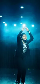 Dancer performing under vibrant blue stage lighting.