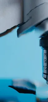 Close-up of a microscope with blue background wallpaper.