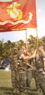 Military ceremony with red flag and soldiers on a sunny day.