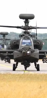 Military helicopters on runway, front view.