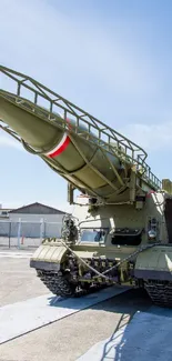 Mobile wallpaper of a military missile launcher under blue sky.