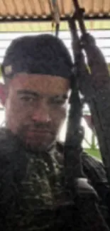 Portrait of a soldier with a rifle, intense look in military setting.