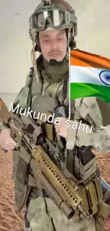 Military soldier holding a rifle in desert with Indian flag background.