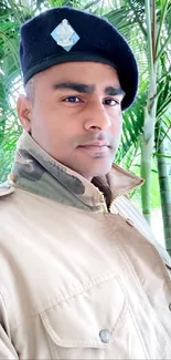 Man in military uniform with green palm background.