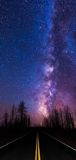 Milky Way stretches above a dark, serene road at night.