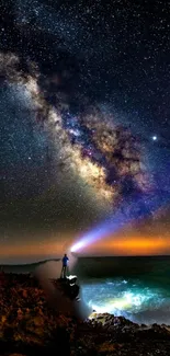 Person on coast gazing at the Milky Way under a starlit night sky.