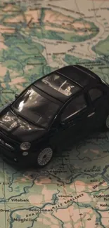 Mini black car on a vintage world map background.