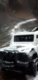 Miniature white truck on a muddy trail.