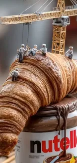Miniature workers on a croissant with Nutella jar.