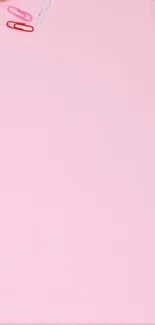 Minimalist pink background with paperclips scattered.