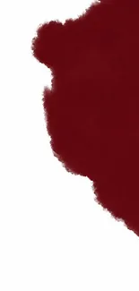 Minimalist red paint splash on white background wallpaper.