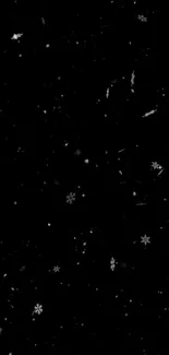 Minimalist wallpaper with snowflakes on black background.