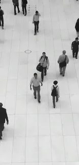 Minimalist black and white wallpaper with people walking on a tiled floor.