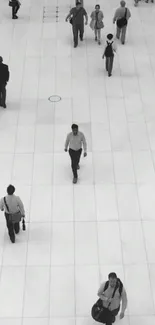 Black and white minimalism with people walking in a large open space.