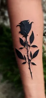 Minimalist black rose tattoo on forearm, artistic mobile wallpaper.