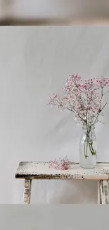 Minimalist wallpaper with pink blossoms on a bench.