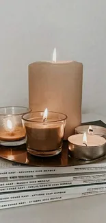 Minimalist candle decor on stacked books.