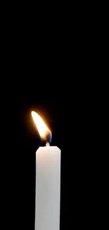 Minimalist candle glow against a dark black background for mobile wallpaper.